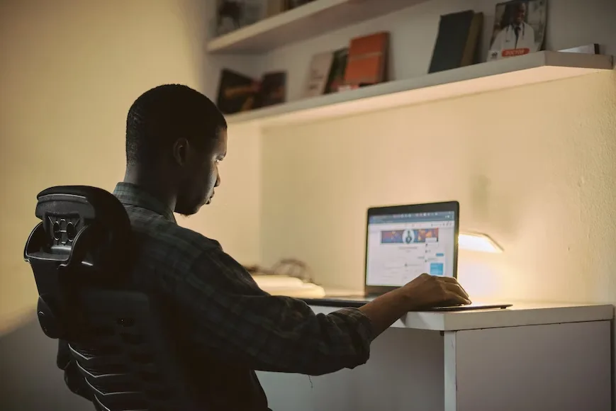 Student studying on a laptop at home